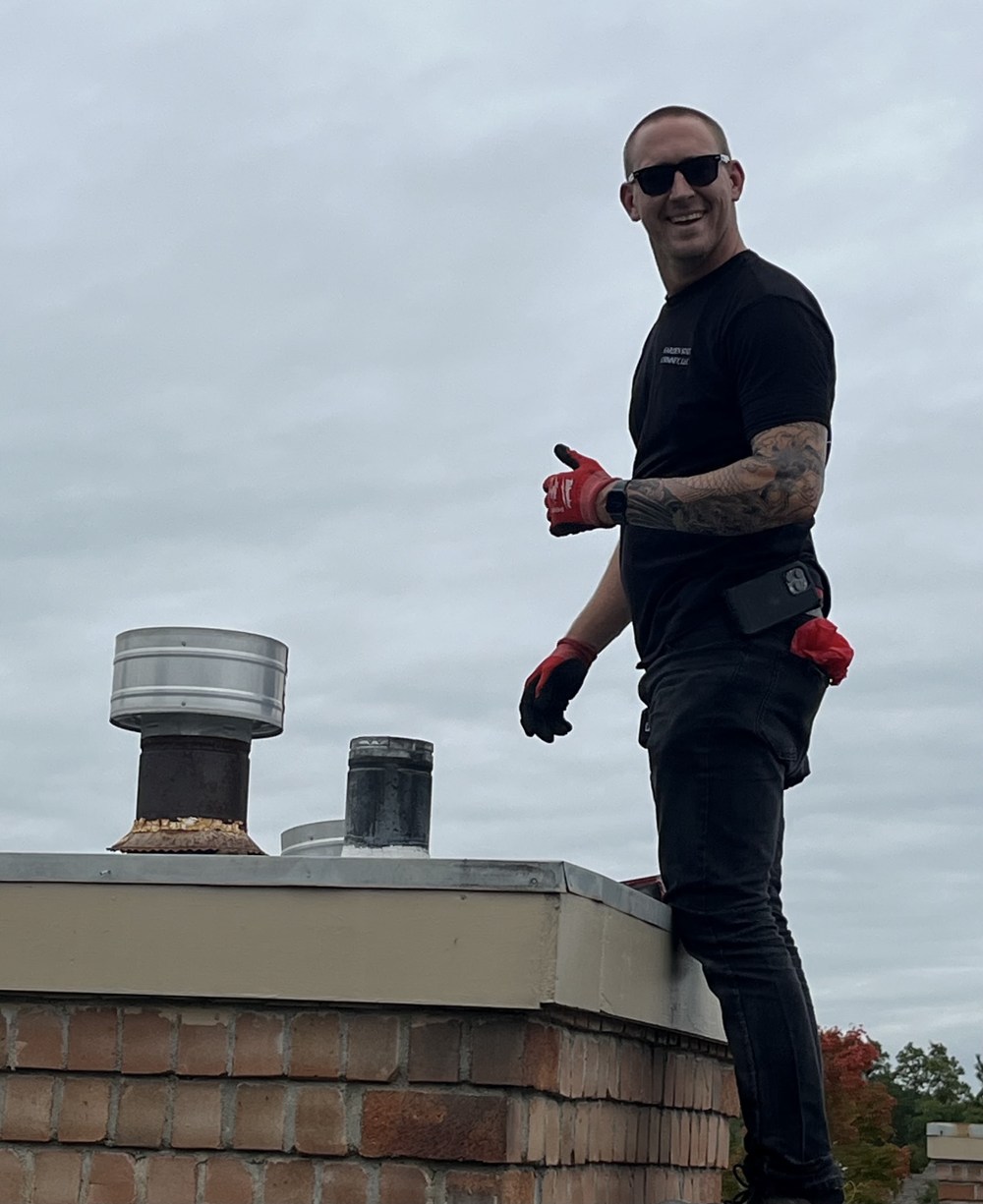 Garden State Chimney technician on a rooftop chimney