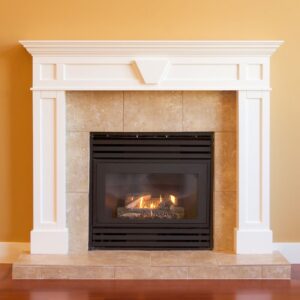 a gas fireplace with a white mantel and surround on an orange-yellow wall